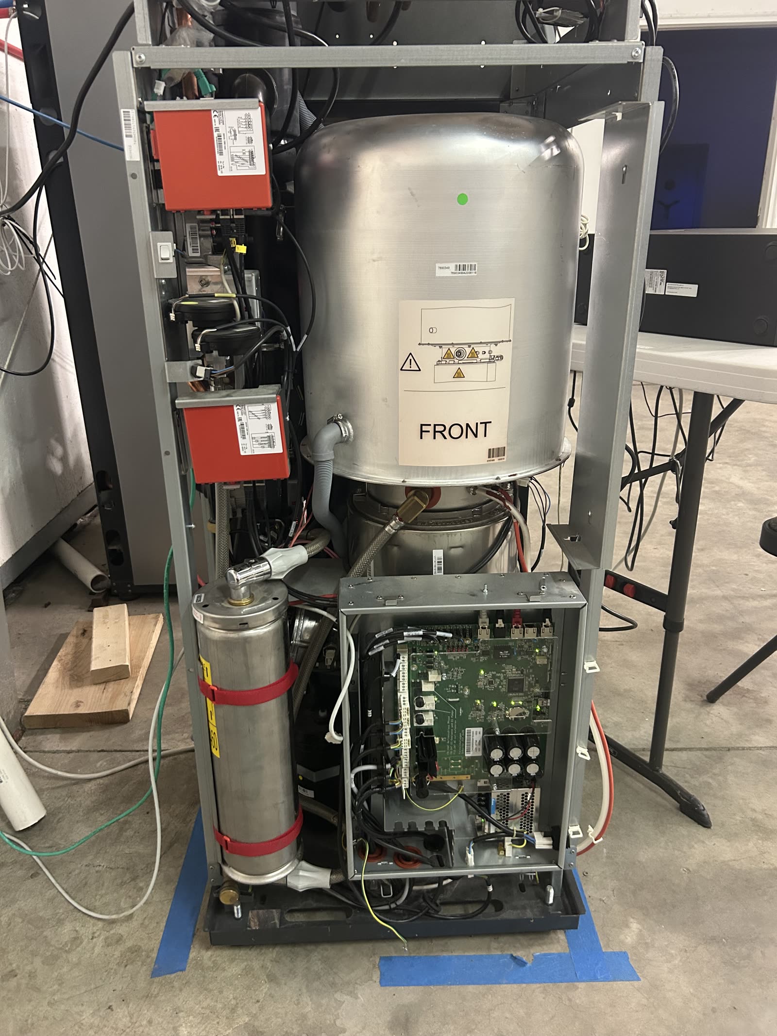 Flux Home unit internal view showing refrigerant lines and wiring routed through the chassis