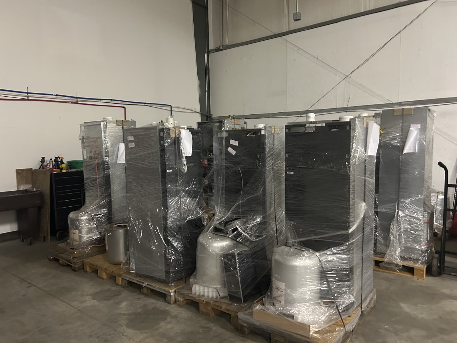Additional row of Flux Home units shrink-wrapped on pallets in the warehouse