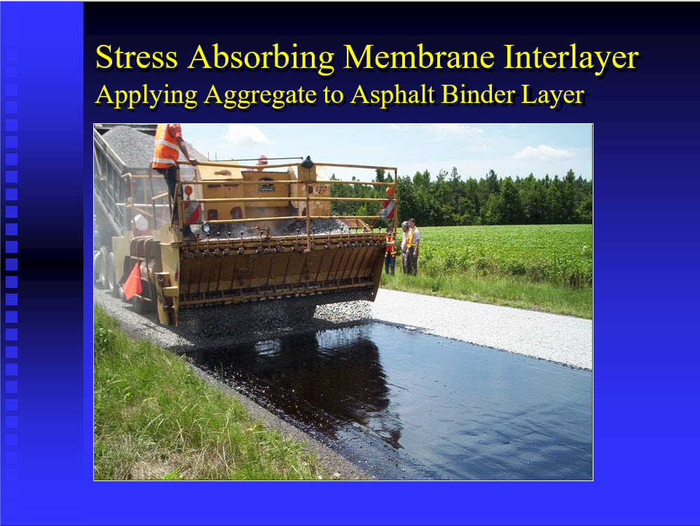 Applying aggregate to an asphalt rubber binder layer as part of a Stress Absorbing Membrane Interlayer installation